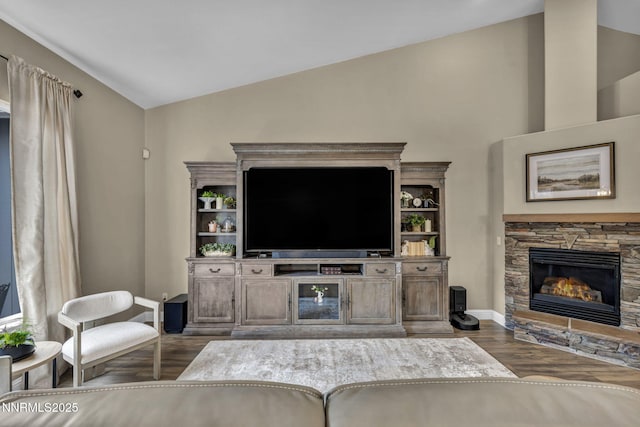 7442 Celeste Dr, Reno, NV 89511 - living area with lofted ceiling, dark wood finished floors, baseboards, and a stone fireplace