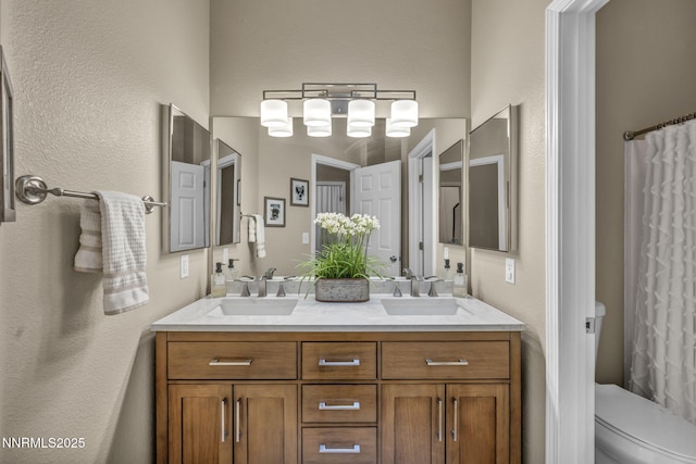 7442 Celeste Dr, Reno, NV 89511 - bathroom featuring a textured wall, double vanity, toilet, and a shower with shower curtain