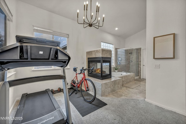 7442 Celeste Dr, Reno, NV 89511 - workout room featuring a tile fireplace, a chandelier, carpet flooring, and baseboards