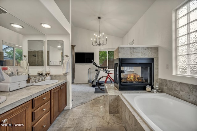 7442 Celeste Dr, Reno, NV 89511 - full bathroom with plenty of natural light, vanity, a bath, a chandelier, and vaulted ceiling