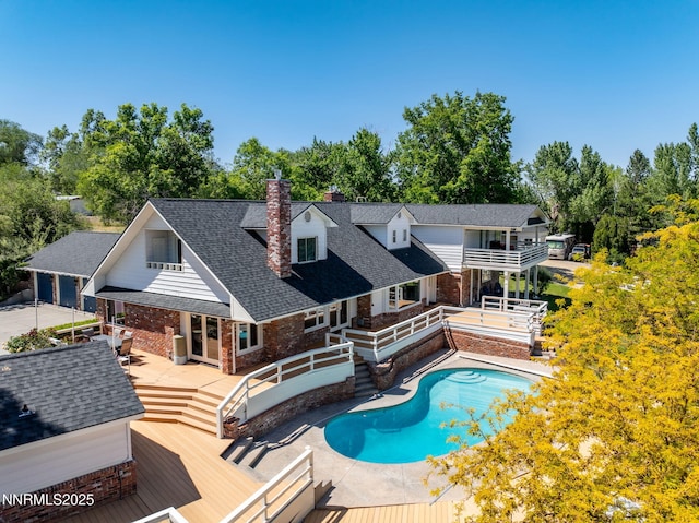 1855 Sierra Sage Ln, Reno, NV 89509 - swimming pool with a deck and view of wooded area