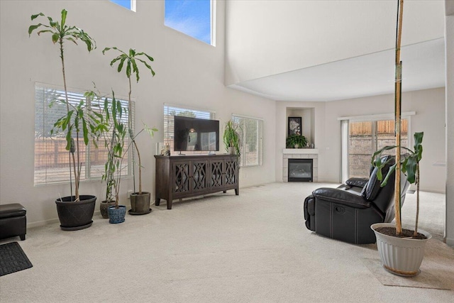 5625 Spandrell Cir, Sparks, NV 89436 - carpeted living area featuring plenty of natural light, a tile fireplace, and a high ceiling