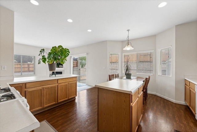 5625 Spandrell Cir, Sparks, NV 89436 - kitchen featuring dark wood-type flooring, light countertops, recessed lighting, hanging light fixtures, and brown cabinets