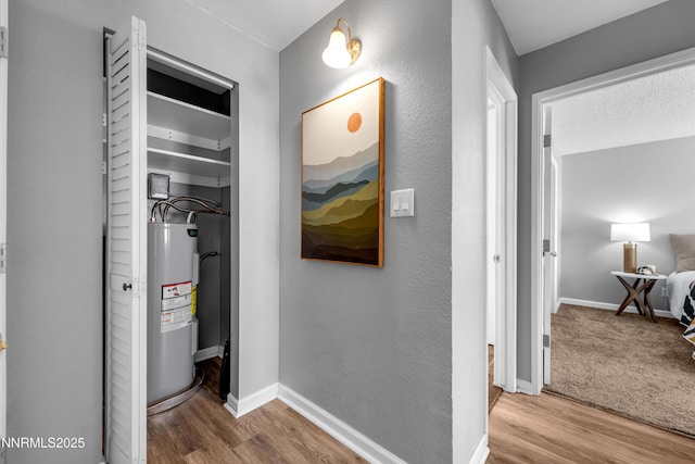 3951 Clear Acre Ln Unit 293, Reno, NV 89512 - corridor with electric water heater, wood finished floors, and baseboards