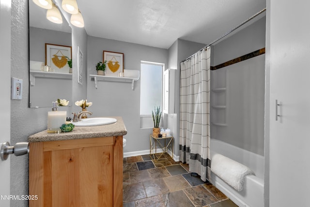 3951 Clear Acre Ln Unit 293, Reno, NV 89512 - bathroom featuring stone tile flooring, baseboards, vanity, and shower / bath combo with shower curtain