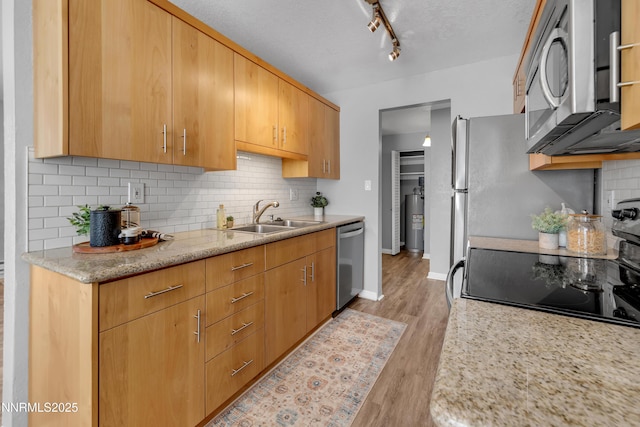 3951 Clear Acre Ln Unit 293, Reno, NV 89512 - kitchen with appliances with stainless steel finishes, a sink, backsplash, water heater, and light wood-style flooring