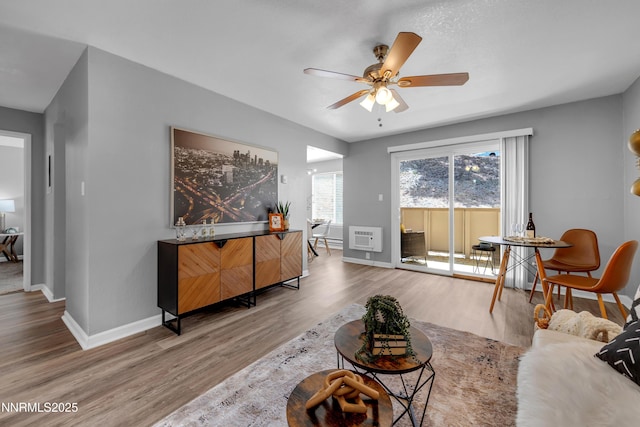 3951 Clear Acre Ln Unit 293, Reno, NV 89512 - living area featuring ceiling fan, wood finished floors, baseboards, and heating unit