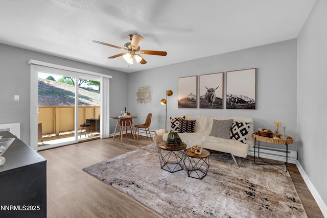 3951 Clear Acre Ln Unit 293, Reno, NV 89512 - living area featuring wood finished floors, ceiling fan, a baseboard radiator, and baseboards