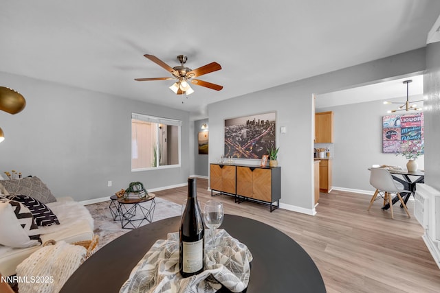 3951 Clear Acre Ln Unit 293, Reno, NV 89512 - living room with a chandelier, light wood-style floors, baseboards, and ceiling fan