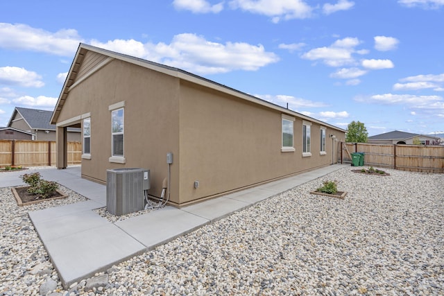 7480 Souverain Ln, Reno, NV 89506 - view of home's exterior with central AC, a patio, a fenced backyard, and stucco siding