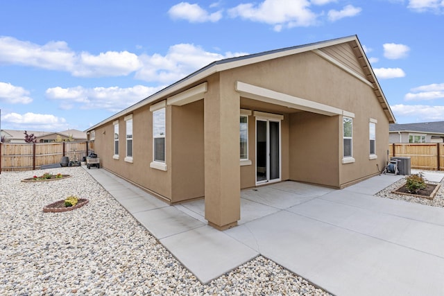 7480 Souverain Ln, Reno, NV 89506 - back of property featuring stucco siding, a patio, a fenced backyard, and cooling unit