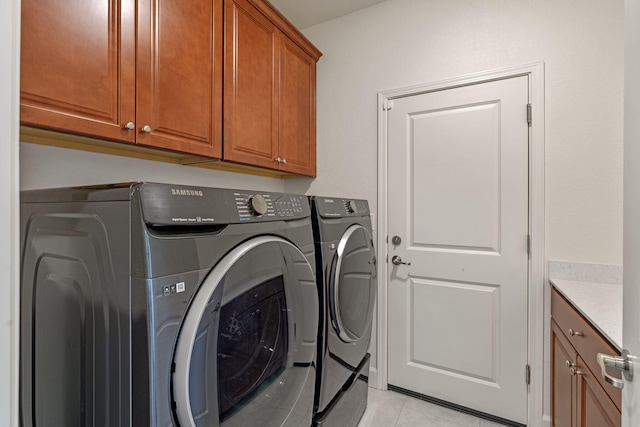 7480 Souverain Ln, Reno, NV 89506 - laundry room featuring cabinet space, washer and clothes dryer, and light tile patterned flooring