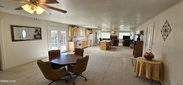 155 James Ct, Kingston, NV 89310 - dining room with ceiling fan, light carpet, a textured ceiling, french doors, and baseboards