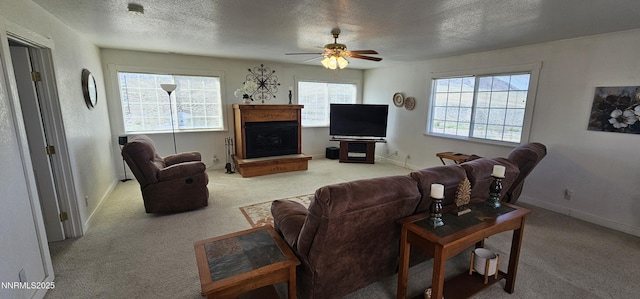 155 James Ct, Kingston, NV 89310 - carpeted living area featuring a ceiling fan, a textured ceiling, a fireplace with raised hearth, and baseboards
