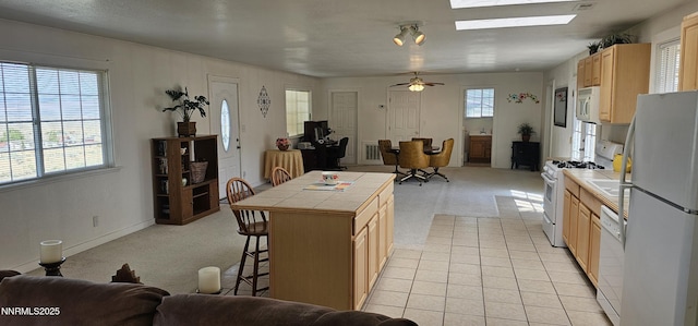 155 James Ct, Kingston, NV 89310 - kitchen featuring tile counters, white appliances, open floor plan, and light brown cabinetry