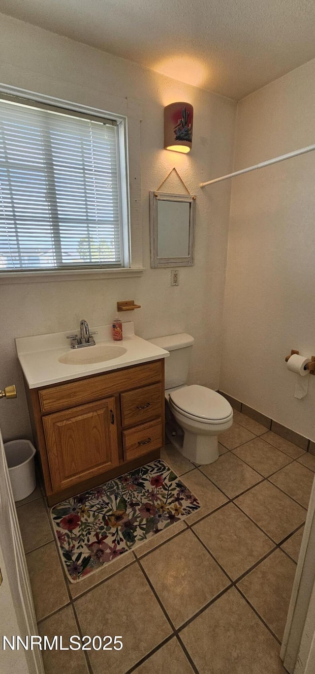155 James Ct, Kingston, NV 89310 - bathroom featuring toilet, vanity, tile patterned floors, and a textured ceiling