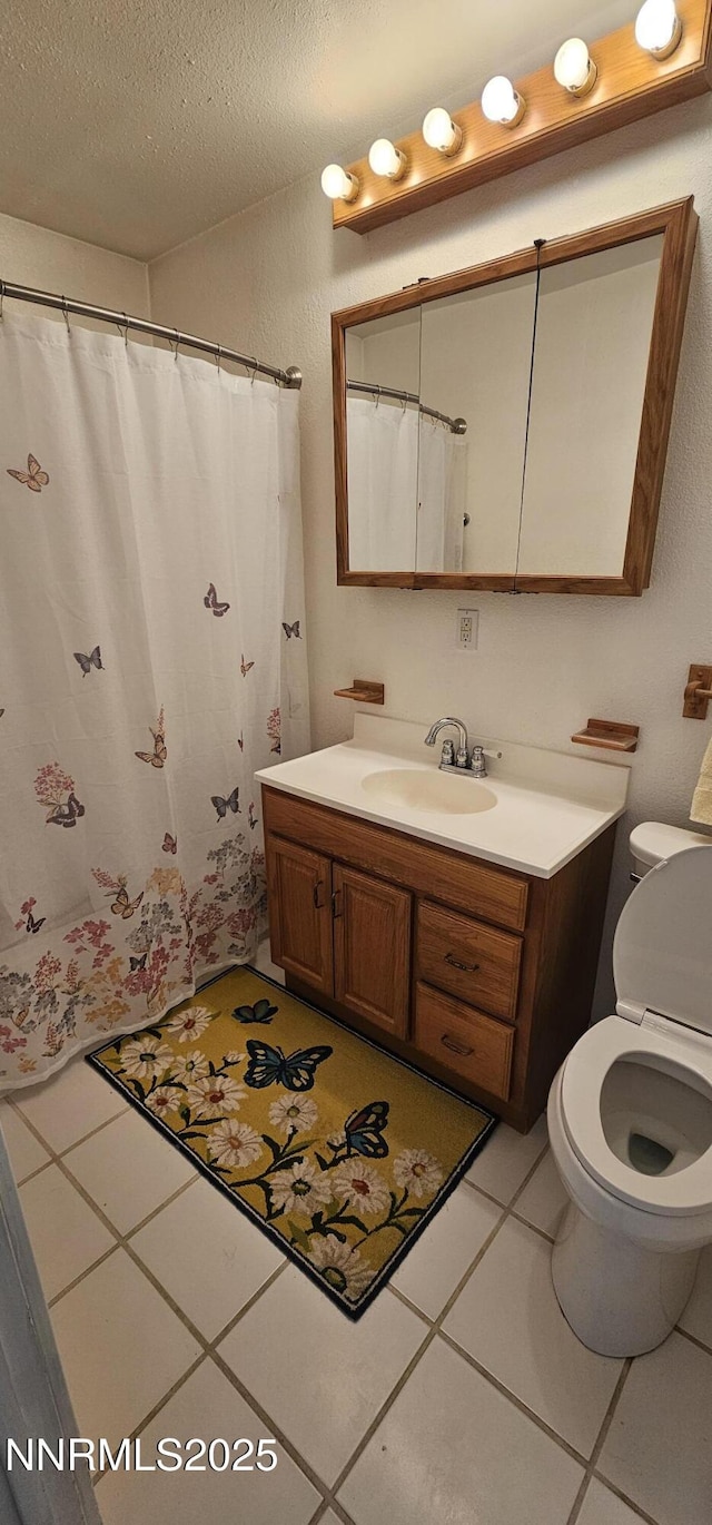 155 James Ct, Kingston, NV 89310 - bathroom with vanity, toilet, a textured ceiling, and tile patterned flooring