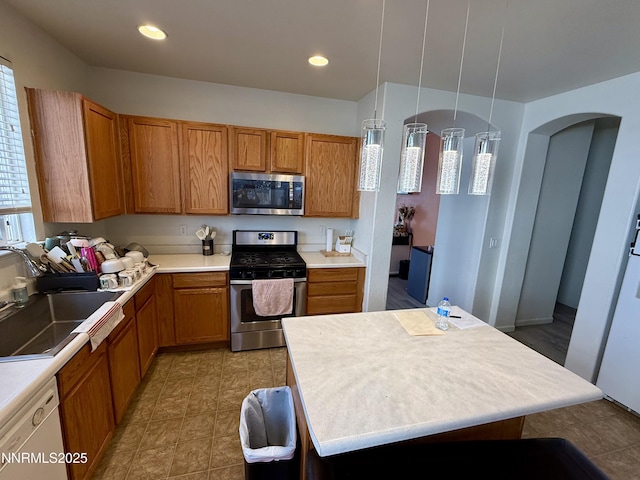 1224 Mountain Rose Dr, Fernley, NV 89408 - kitchen with appliances with stainless steel finishes, brown cabinets, a sink, light countertops, and recessed lighting