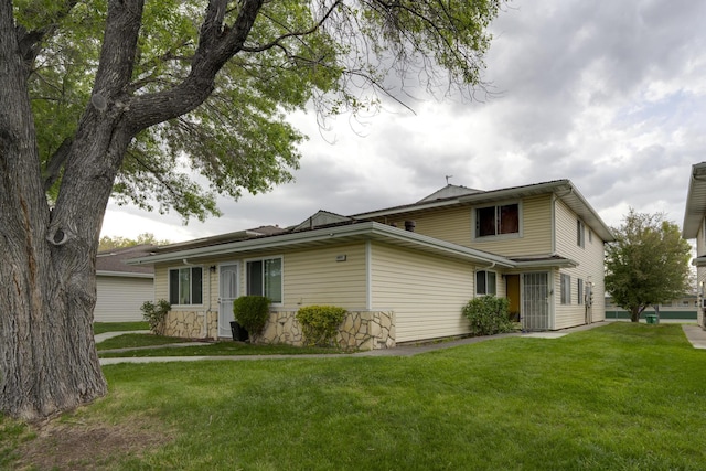 4941 Catalina Dr Apt 2, Reno, NV 89502 - view of front facade featuring a front lawn and stone siding