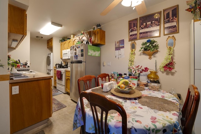 4941 Catalina Dr Apt 2, Reno, NV 89502 - dining space featuring stacked washing machine and dryer, a ceiling fan, and light tile patterned flooring