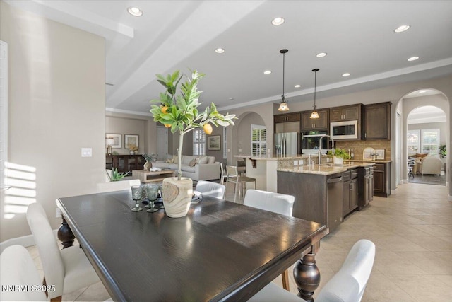 2675 Weymoor Ct, Reno, NV 89521 - dining room featuring arched walkways, light tile patterned floors, recessed lighting, crown molding, and baseboards