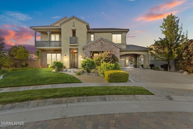 2675 Weymoor Ct, Reno, NV 89521 - view of front of home with a balcony, decorative driveway, stucco siding, and stone siding