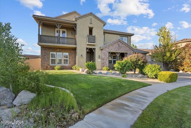 2675 Weymoor Ct, Reno, NV 89521 - view of front facade with a balcony, a front yard, and stucco siding