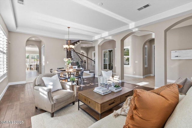 2675 Weymoor Ct, Reno, NV 89521 - living room featuring arched walkways, stairway, a chandelier, wood-type flooring, and baseboards