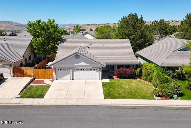 4515 Vista Mountain Dr, Sparks, NV 89436 - ranch-style house featuring an attached garage, driveway, a mountain view, and a tile roof