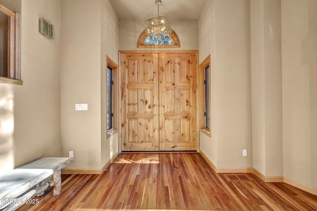 1445 Austrian Pine Rd, Reno, NV 89511 - entrance foyer featuring wood finished floors, a chandelier, baseboards, and a high ceiling