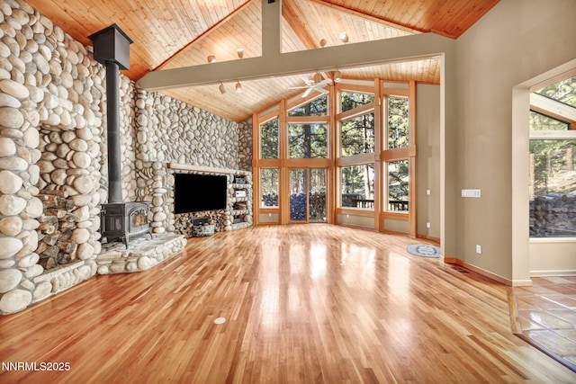 1445 Austrian Pine Rd, Reno, NV 89511 - unfurnished living room with a wood stove, ceiling fan, high vaulted ceiling, wood ceiling with exposed beams, and wood finished floors