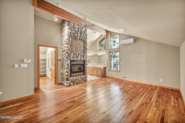 1445 Austrian Pine Rd, Reno, NV 89511 - unfurnished living room with an AC wall unit, ceiling fan, light wood-style flooring, a fireplace, and baseboards