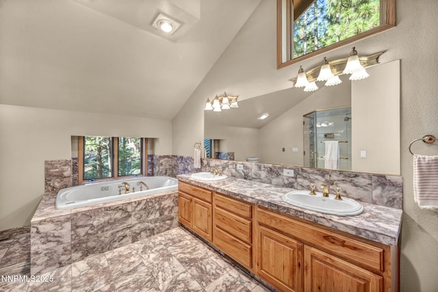 1445 Austrian Pine Rd, Reno, NV 89511 - full bath with plenty of natural light, marble look tiles, a bath, double vanity, and vaulted ceiling