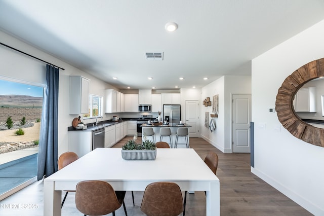 7609 Apex Pl # 113, Reno, NV 89506 - dining room with baseboards, wood finished floors, and recessed lighting