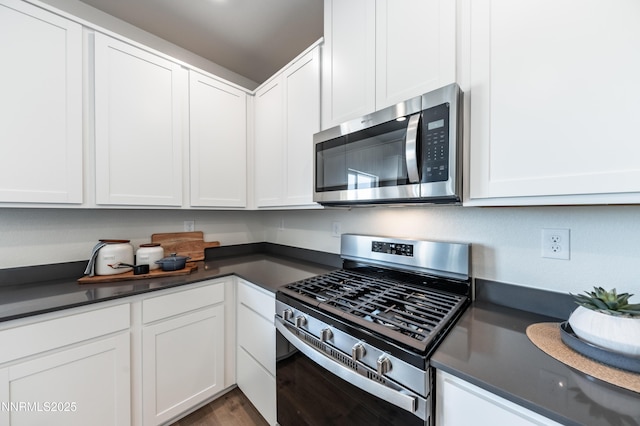 7609 Apex Pl # 113, Reno, NV 89506 - kitchen with stainless steel appliances, dark countertops, and white cabinetry