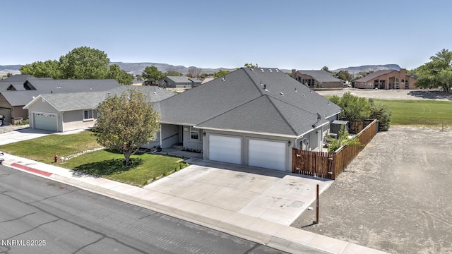 240 Mary Lou Ln, Fernley, NV 89408 - ranch-style home with a garage, concrete driveway, a mountain view, roof with shingles, and a residential view
