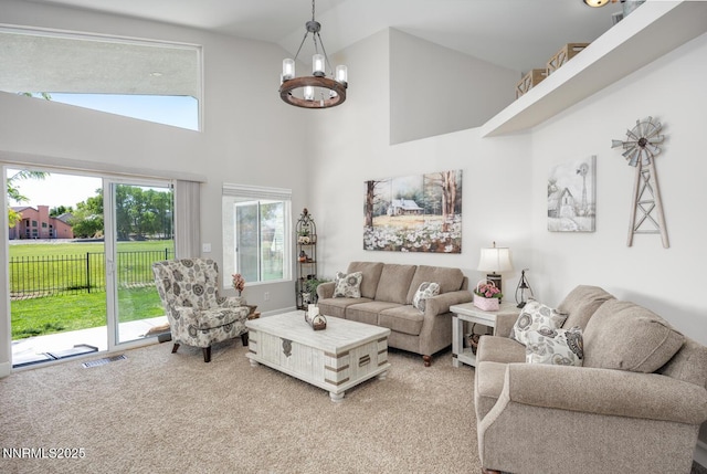 240 Mary Lou Ln, Fernley, NV 89408 - living room with light colored carpet, high vaulted ceiling, and a chandelier