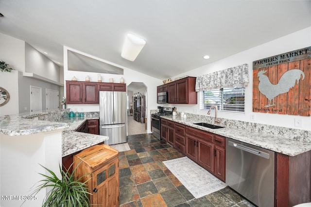 240 Mary Lou Ln, Fernley, NV 89408 - kitchen featuring stainless steel appliances, a sink, dark stone finish floors, lofted ceiling, and arched walkways