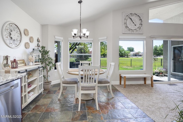 240 Mary Lou Ln, Fernley, NV 89408 - dining area featuring stone tile flooring, healthy amount of natural light, a chandelier, baseboards, and high vaulted ceiling