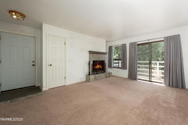 769 Tina Ct # H, Stateline, NV 89449 - unfurnished living room featuring carpet flooring, a fireplace, and baseboards