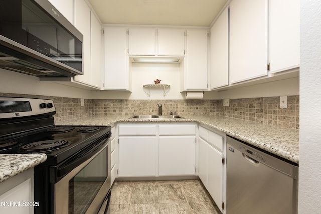 769 Tina Ct # H, Stateline, NV 89449 - kitchen featuring appliances with stainless steel finishes, a sink, decorative backsplash, and white cabinets