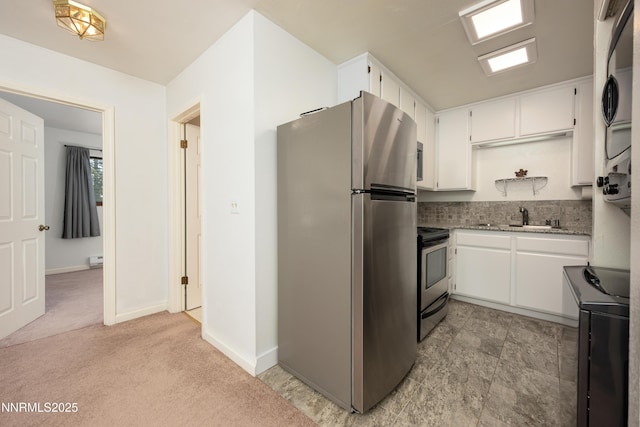769 Tina Ct # H, Stateline, NV 89449 - kitchen featuring stainless steel appliances, stacked washer / drying machine, a sink, white cabinetry, and light stone counters