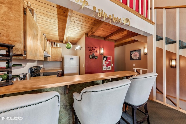 383 Tramway Dr Unit B, Stateline, NV 89449 - kitchen with electric stove, freestanding refrigerator, wood ceiling with exposed beams, under cabinet range hood, and wood counters