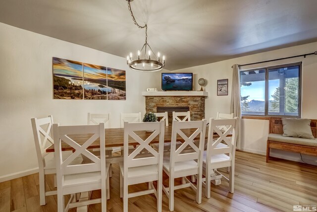 758 Milky Way Ct Unit B, Stateline, NV 89449 - dining space with a chandelier, light wood-style flooring, baseboards, and a stone fireplace