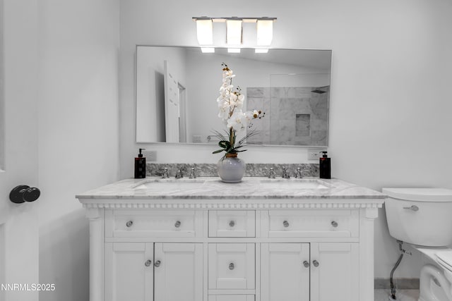 4360 Slide Mountain Cir, Reno, NV 89511 - bathroom featuring toilet, a tile shower, and double vanity