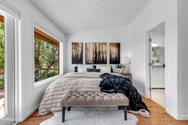 4360 Slide Mountain Cir, Reno, NV 89511 - bedroom with wood finished floors, vaulted ceiling, baseboards, and ensuite bathroom
