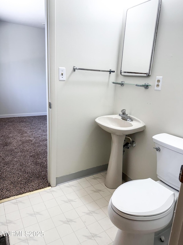 604 W Winnie Ln, Carson City, NV 89703 - half bathroom with toilet, baseboards, and a sink