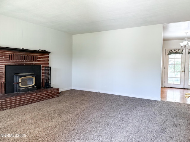 604 W Winnie Ln, Carson City, NV 89703 - unfurnished living room featuring carpet flooring, baseboards, and a chandelier