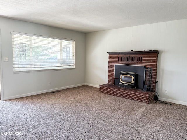 604 W Winnie Ln, Carson City, NV 89703 - unfurnished living room with a wood stove, a textured ceiling, carpet floors, and baseboards