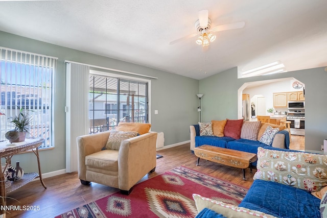 244 Ave De La Couleurs Ave, Sparks, NV 89434 - living room featuring a ceiling fan, wood finished floors, baseboards, and arched walkways